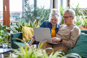 Life Assure Senior Woman Sitting In Chair And Laughing With Caregiver Nurse Blog